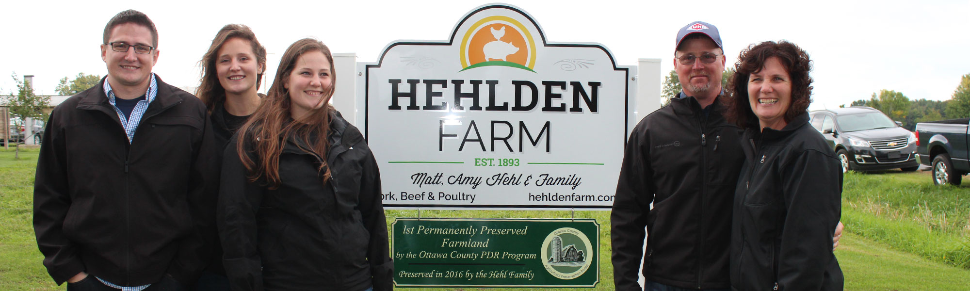 matt hehl family in front of sign